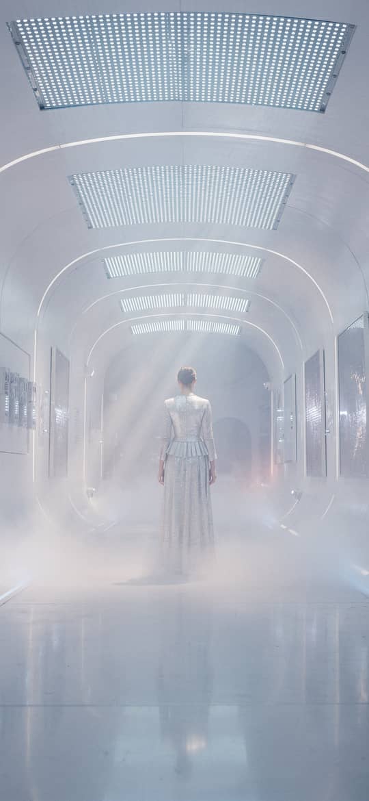 Woman in White Dress Walking Futuristic Corridor