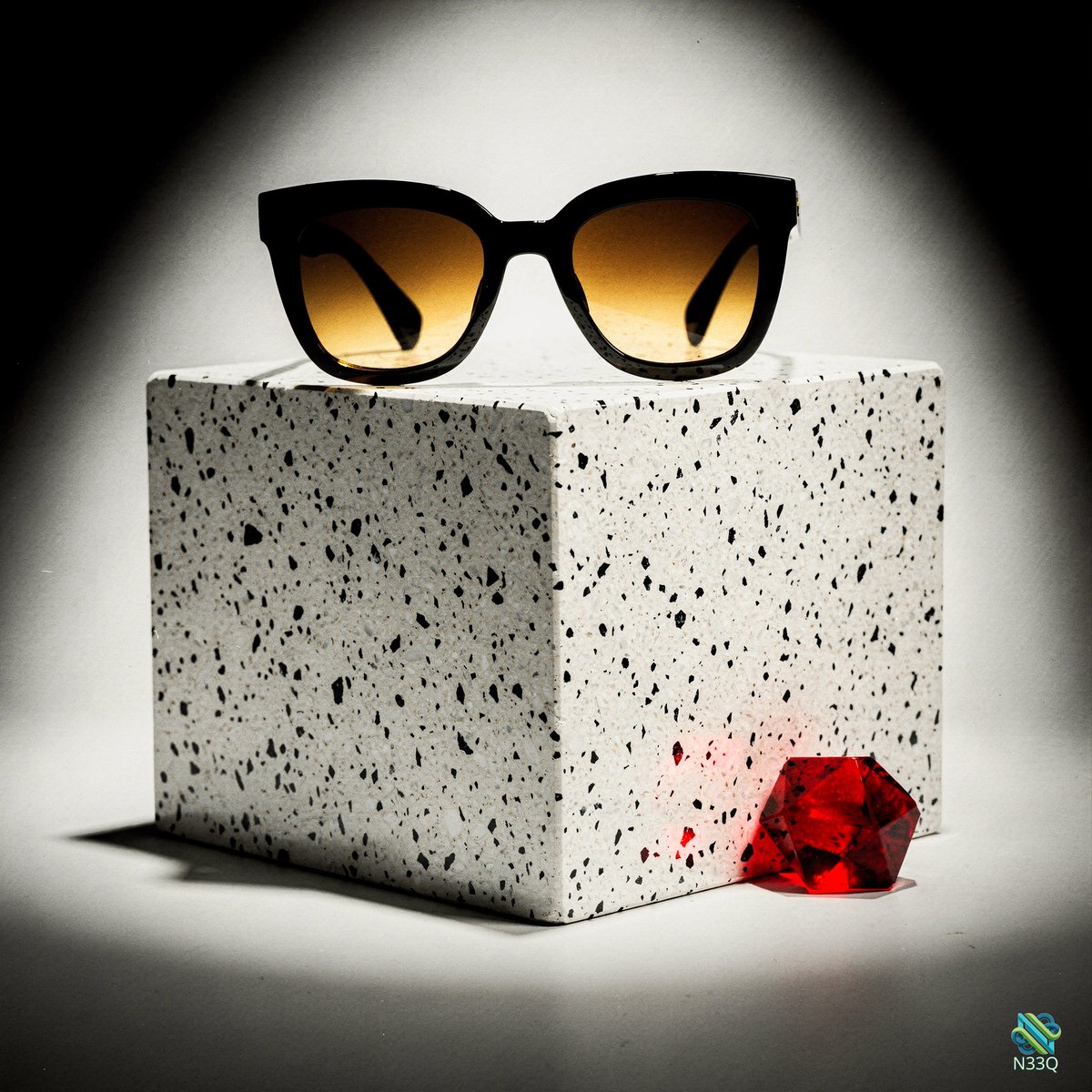 Sunglasses on Speckled Cube with Red Gem