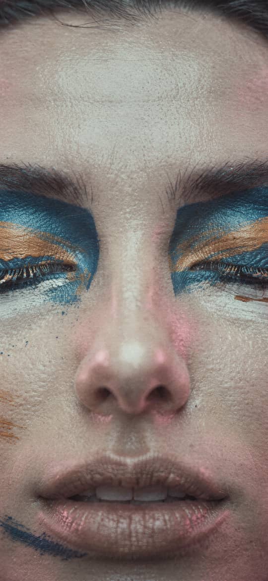 Woman with Bold Multicolored Face Makeup