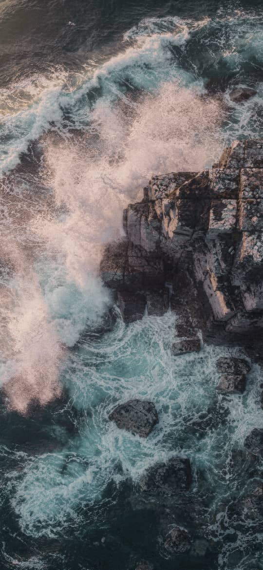Waves Crashing Against Rocky Coastal Cliffs