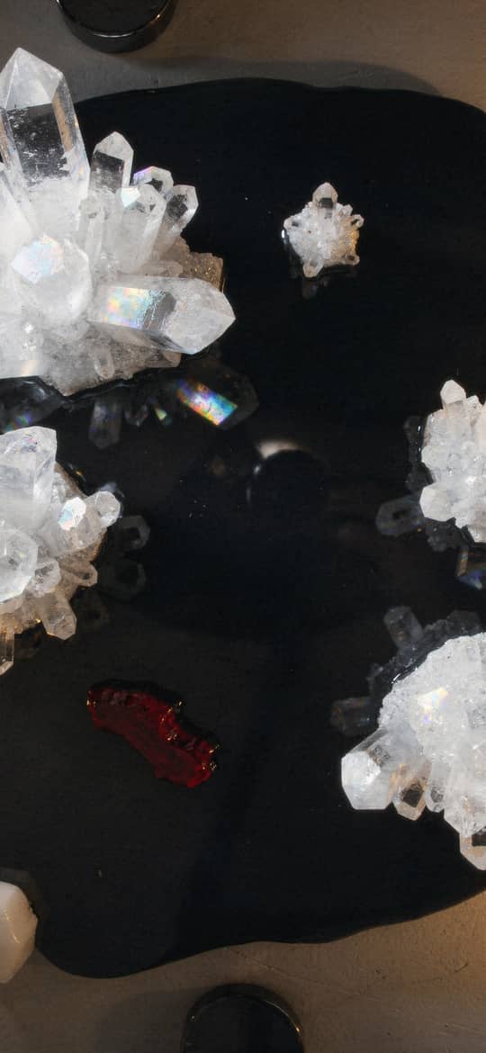 Quartz Crystal Clusters on Black Surface with Candles