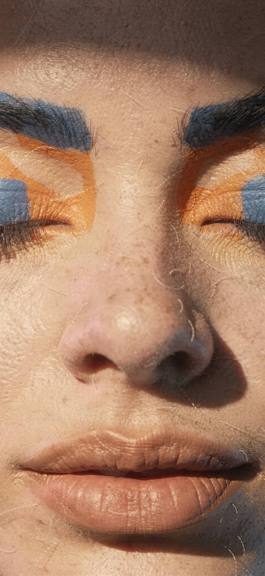 Freckled Woman with Bold Blue Orange Eyeshadow