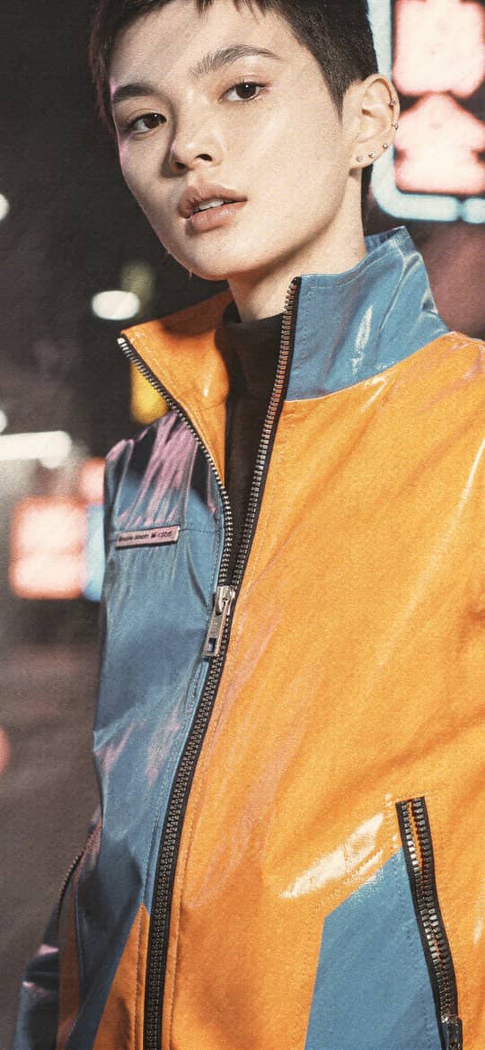 Man in Orange Blue Jacket Under Neon Lights