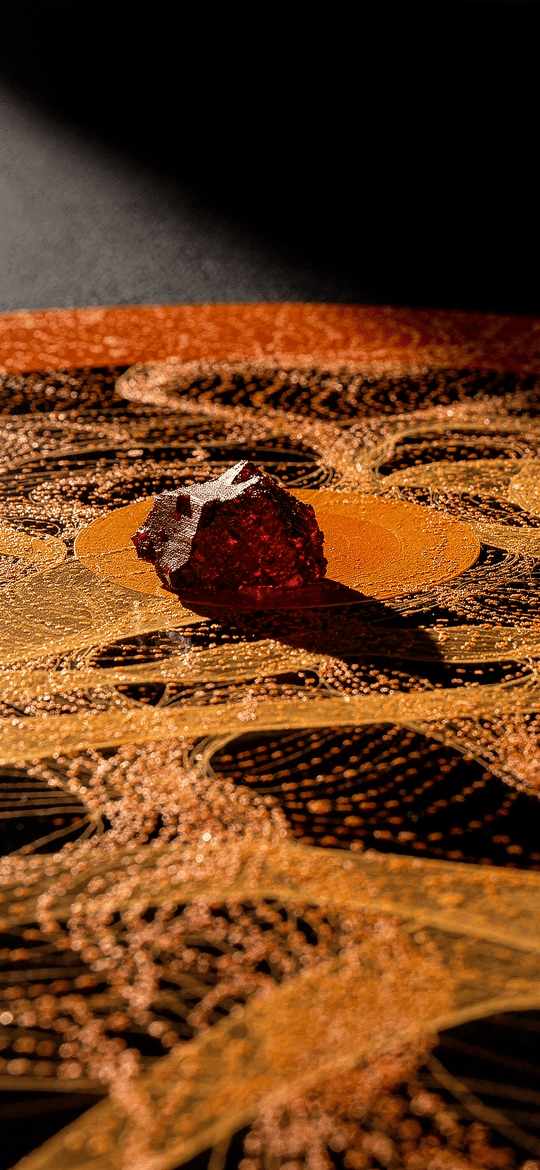 Red Stone on a Glowing Orange Contour Map