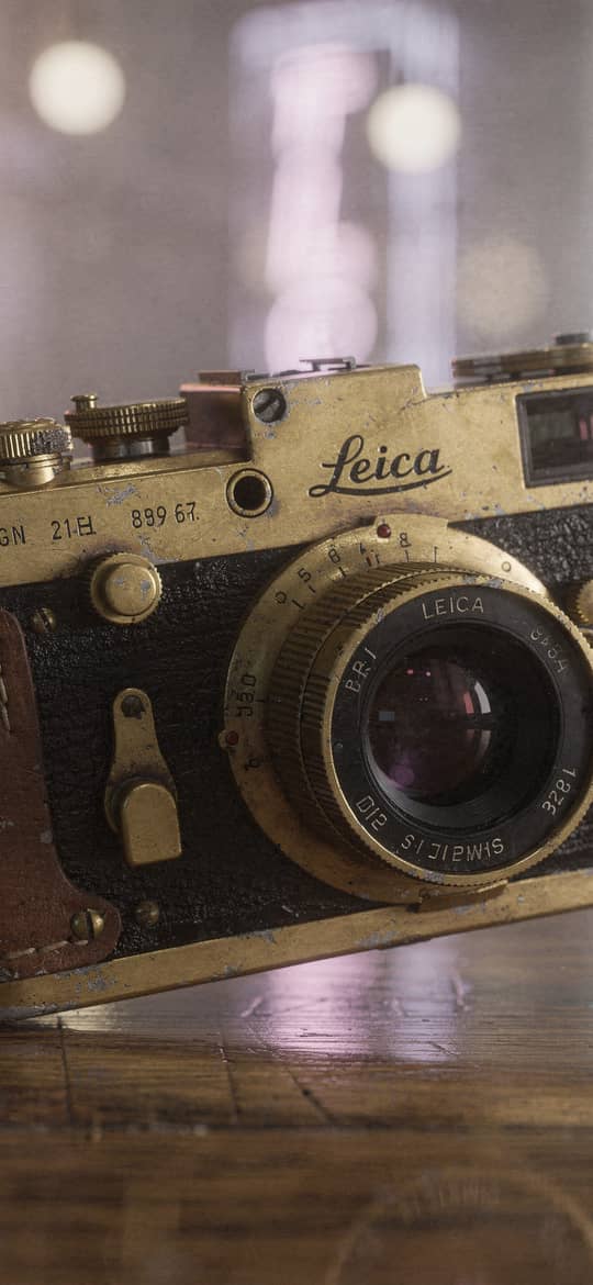 Vintage Brass Leica Camera on Wood
