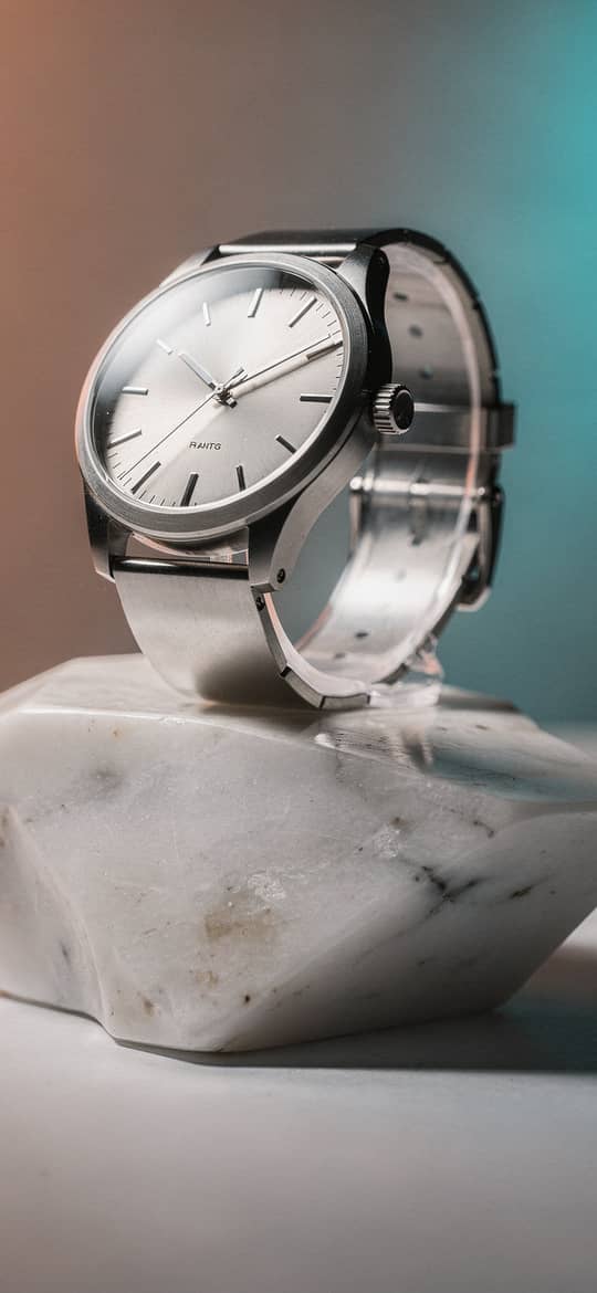 Silver Watch on Marble Stand